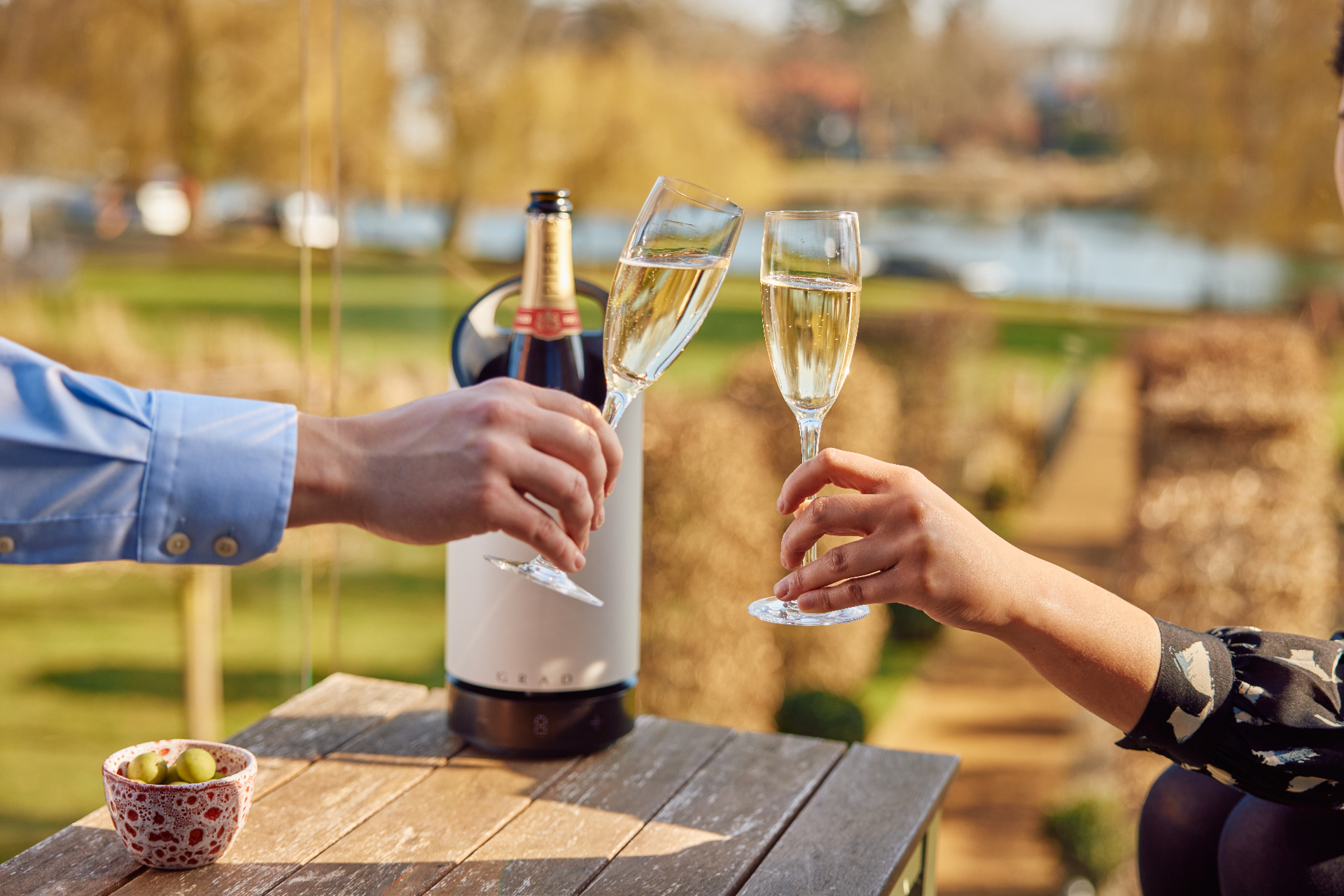 Toasting with GRAD wine cooler by the water