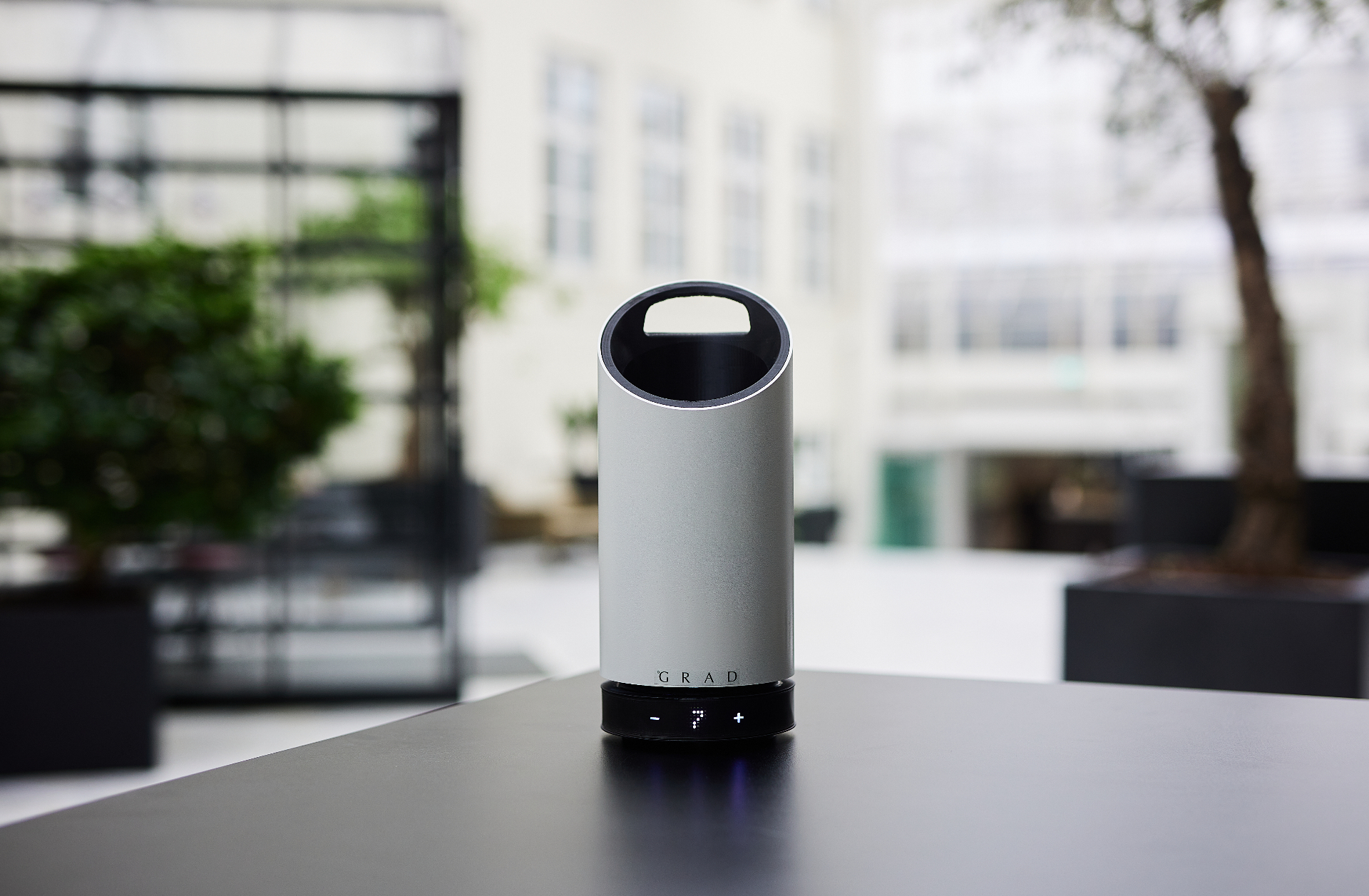 GRAD wine cooler on a dark surface showing the minimalist cylindrical design