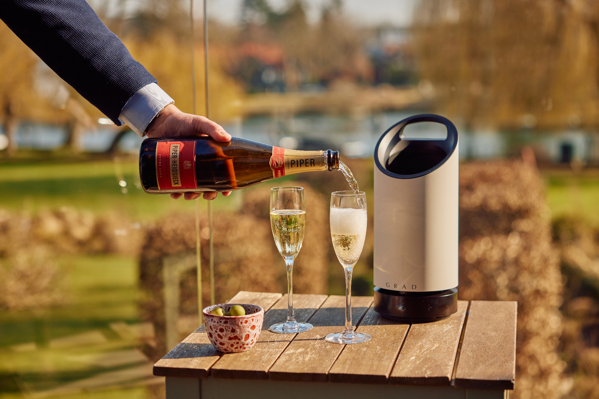 Piper-Heidsieck champagne being poured beside a GRAD wine cooler